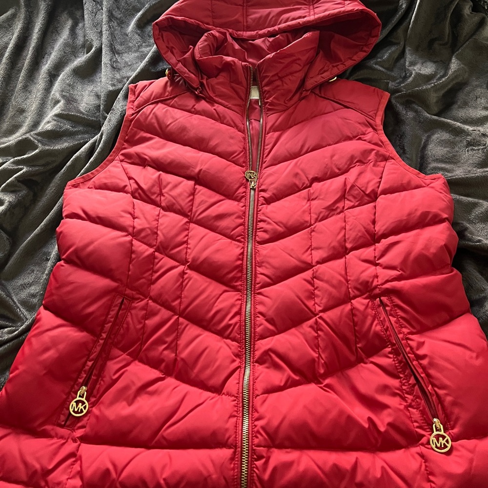 Michael Kors down vest with gold details.